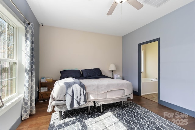 bedroom featuring ceiling fan, visible vents, and wood finished floors