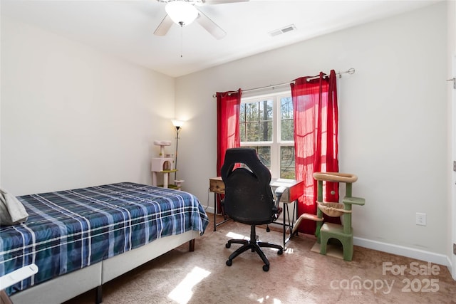 carpeted bedroom with baseboards, a ceiling fan, and visible vents
