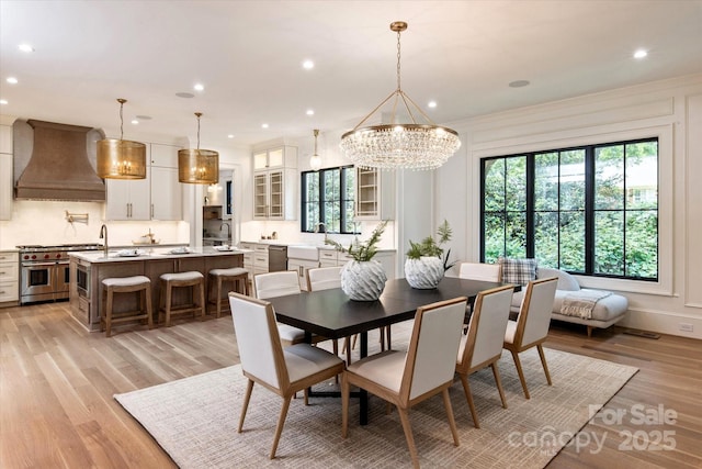 dining room with recessed lighting, plenty of natural light, and light wood finished floors