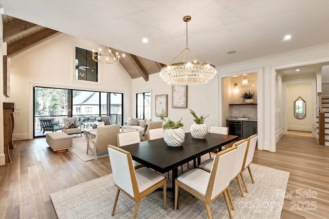 dining area with high vaulted ceiling, light wood-type flooring, beam ceiling, and a notable chandelier