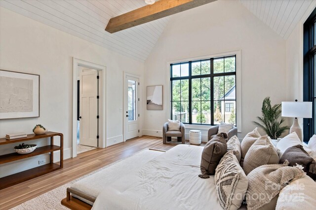 bedroom featuring beam ceiling, baseboards, high vaulted ceiling, wooden ceiling, and light wood-style floors