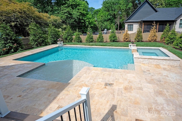 view of swimming pool featuring a pool with connected hot tub, a fenced backyard, and a patio area
