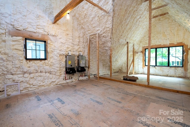 unfurnished living room with a towering ceiling