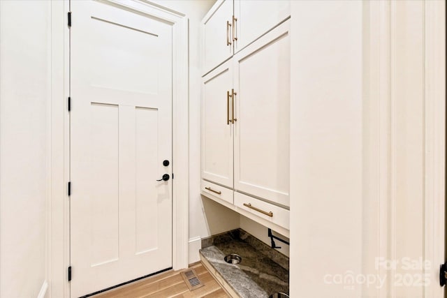 mudroom featuring visible vents and light wood-style flooring
