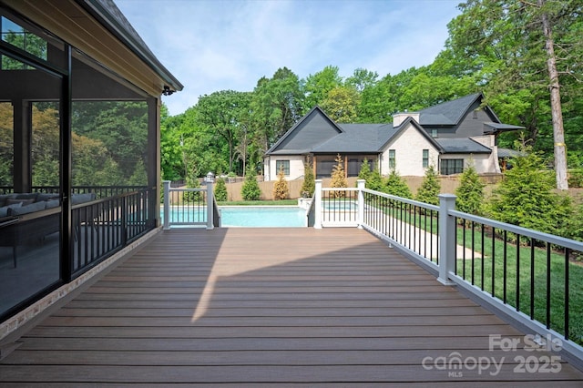 wooden deck featuring a fenced in pool and a fenced backyard
