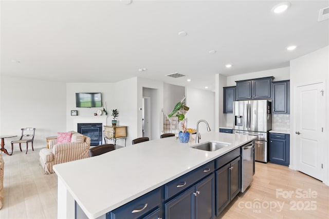 4069 Havenport Cir, Tega Cay, SC 29708 - kitchen featuring a sink, appliances with stainless steel finishes, light countertops, a kitchen island with sink, and open floor plan