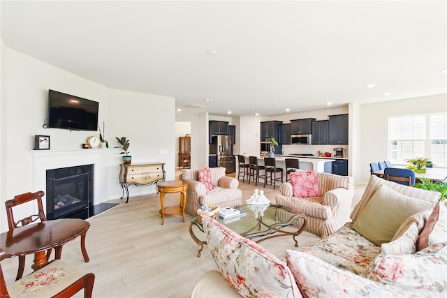 4069 Havenport Cir, Tega Cay, SC 29708 - living area with light wood-style flooring, recessed lighting, and a glass covered fireplace