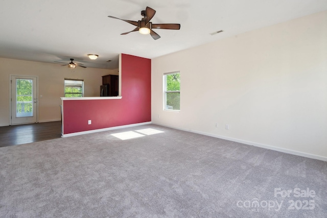 1175 Valley St Unit 111, Statesville, NC 28677 - unfurnished room featuring a ceiling fan, baseboards, dark colored carpet, and visible vents