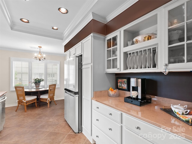 671 S Haywood St Unit 108B, Waynesville, NC 28786 - kitchen featuring crown molding, light tile patterned floors, an inviting chandelier, stainless steel appliances, and white cabinetry