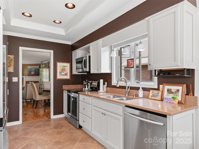 671 S Haywood St Unit 108B, Waynesville, NC 28786 - kitchen with white cabinetry, appliances with stainless steel finishes, ornamental molding, and a sink