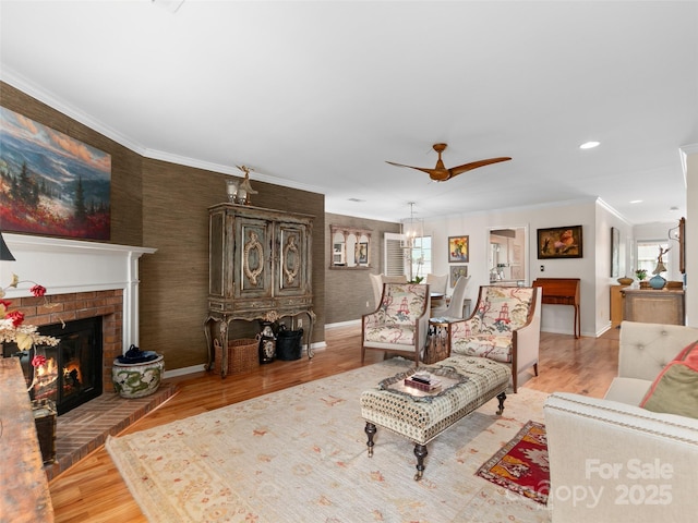 671 S Haywood St Unit 108B, Waynesville, NC 28786 - living area featuring crown molding, a fireplace, light wood-style floors, a ceiling fan, and baseboards