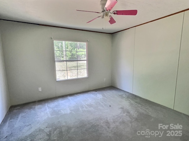 spare room featuring carpet floors and a ceiling fan