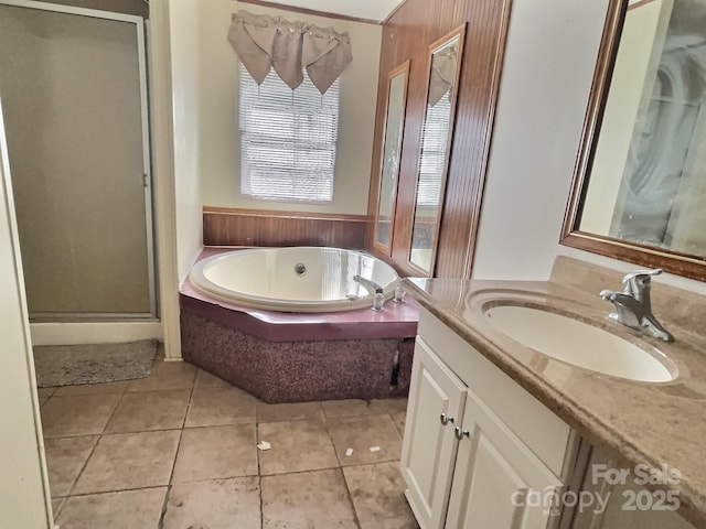 full bath with vanity, tile patterned flooring, a shower stall, and a garden tub