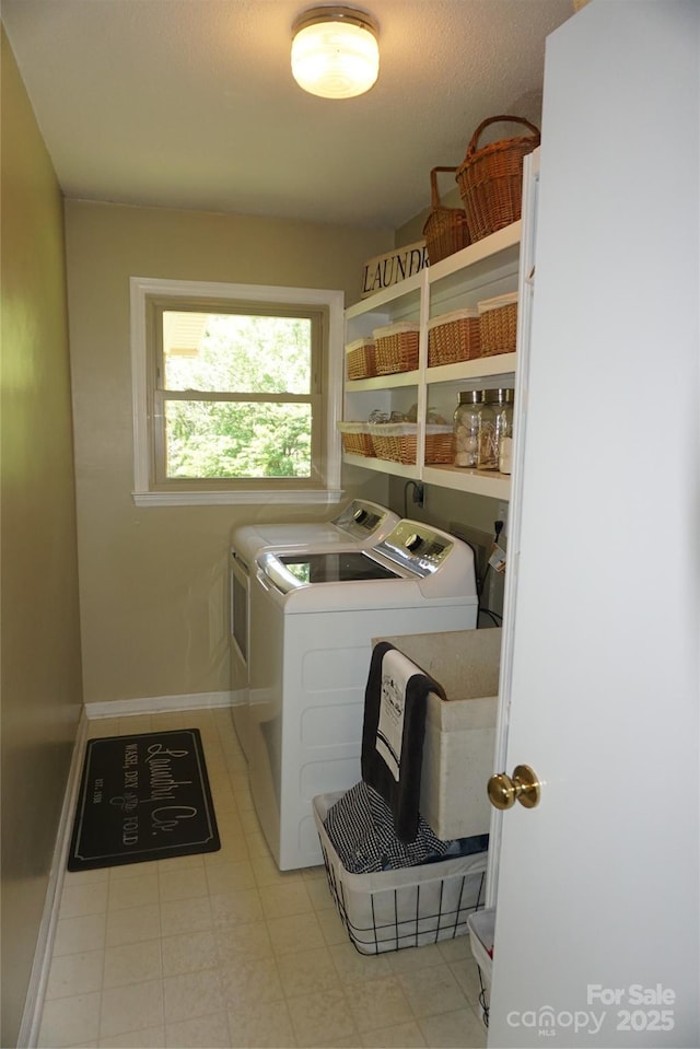 laundry room featuring baseboards, laundry area, and washer and clothes dryer