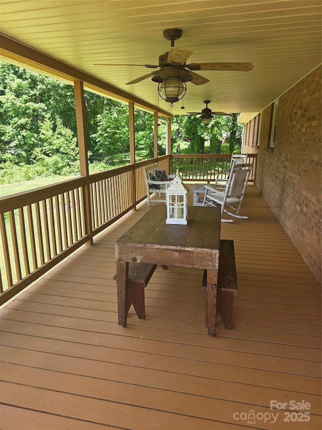 wooden deck with a ceiling fan