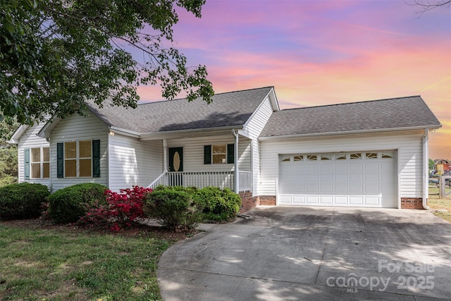 ranch-style home with a garage, concrete driveway, a porch, and roof with shingles