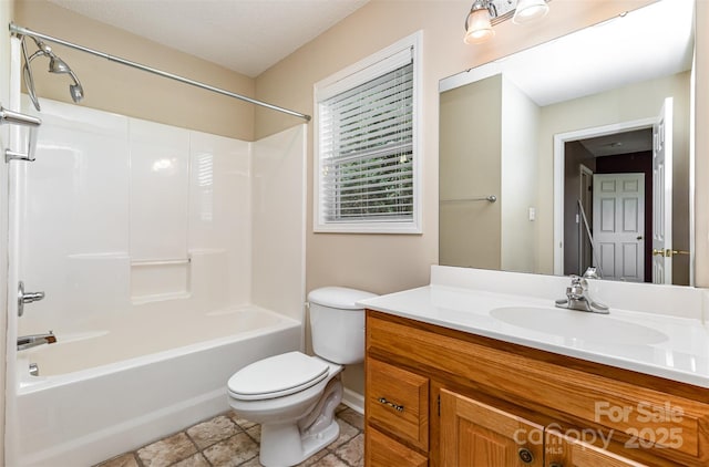 full bathroom featuring toilet, baseboards, washtub / shower combination, and vanity