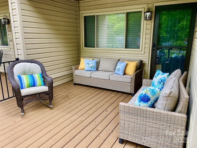 wooden deck with an outdoor living space