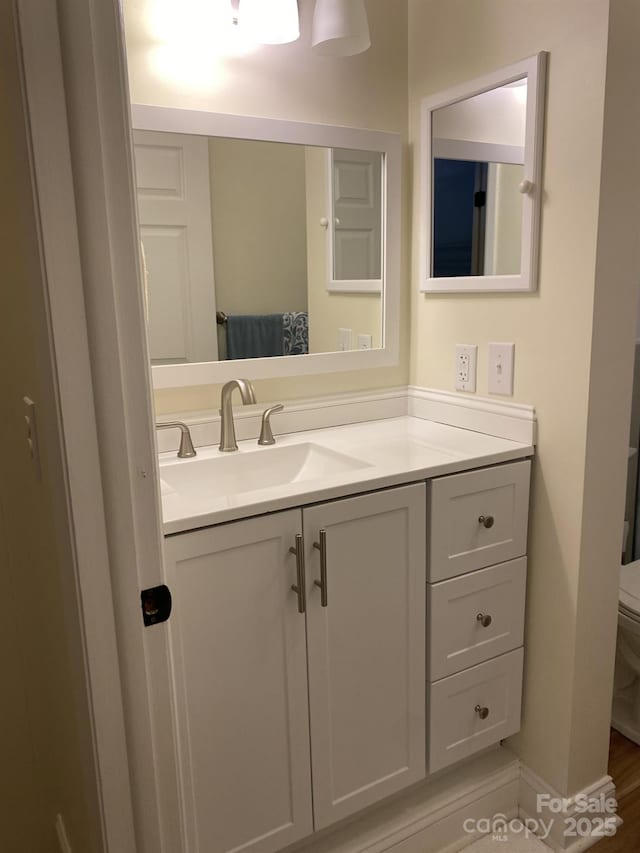 bathroom featuring vanity and toilet