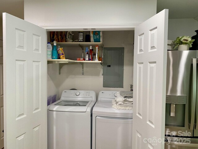 clothes washing area with electric panel and independent washer and dryer