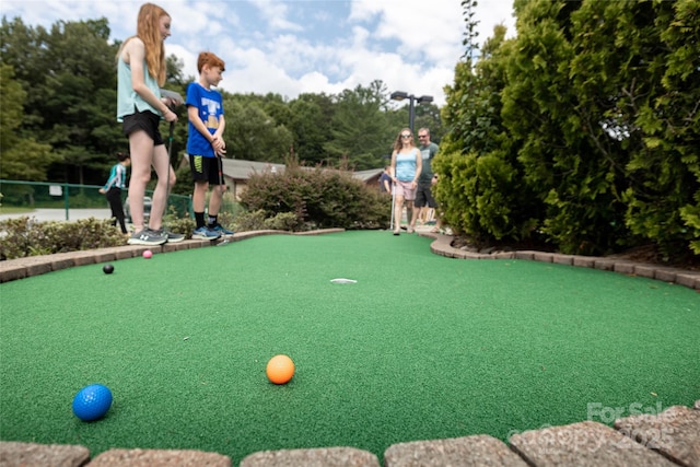 view of home's community with a putting area