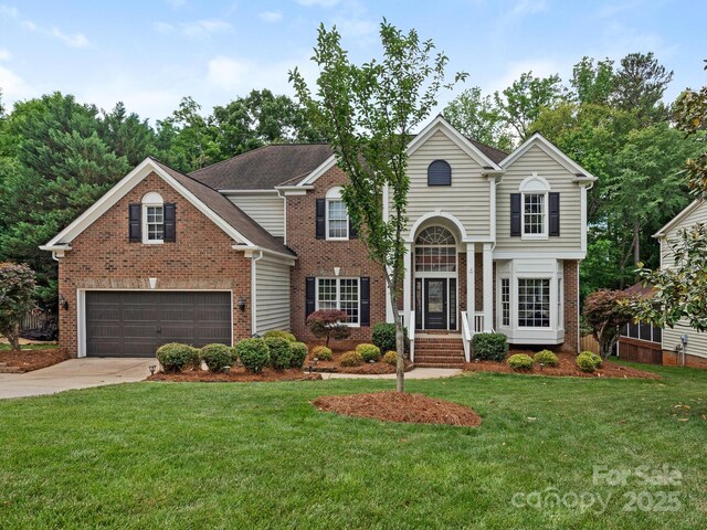 3721 Providence Plantation Ln, Charlotte, NC 28270 - traditional-style home featuring brick siding, driveway, a front lawn, and a garage