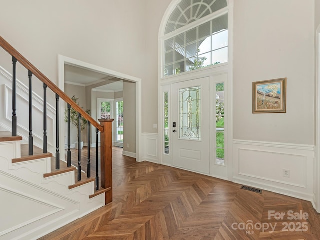 3721 Providence Plantation Ln, Charlotte, NC 28270 - entryway featuring stairs, wainscoting, a towering ceiling, and a decorative wall