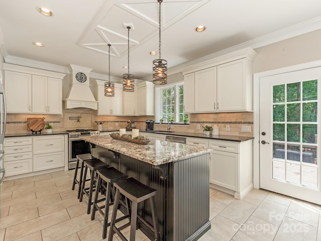 3721 Providence Plantation Ln, Charlotte, NC 28270 - kitchen featuring appliances with stainless steel finishes, a sink, light tile patterned flooring, a kitchen island, and crown molding