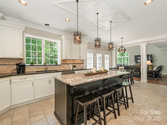 3721 Providence Plantation Ln, Charlotte, NC 28270 - kitchen with a sink, a kitchen island, backsplash, healthy amount of natural light, and recessed lighting