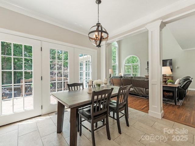 3721 Providence Plantation Ln, Charlotte, NC 28270 - dining space with light tile patterned floors, a chandelier, crown molding, and ornate columns