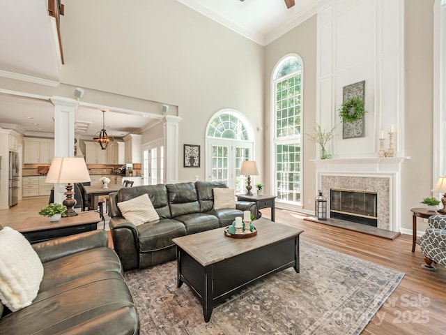 3721 Providence Plantation Ln, Charlotte, NC 28270 - living area with a towering ceiling, ceiling fan, ornamental molding, ornate columns, and a fireplace