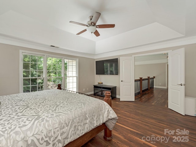 3721 Providence Plantation Ln, Charlotte, NC 28270 - bedroom featuring a tray ceiling, dark wood-style floors, ornamental molding, a ceiling fan, and baseboards