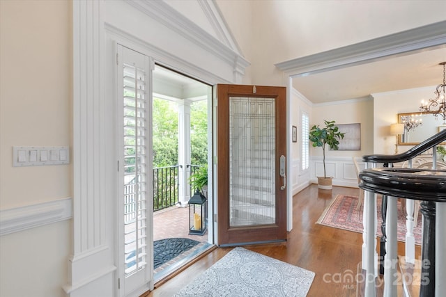 12048 Royal Portrush Dr, Charlotte, NC 28277 - entrance foyer with crown molding, a decorative wall, wood finished floors, a wainscoted wall, and a chandelier