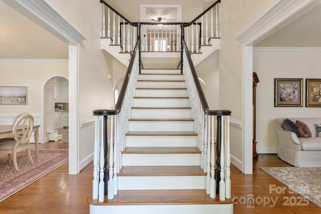 12048 Royal Portrush Dr, Charlotte, NC 28277 - stairs with arched walkways, ornamental molding, and wood finished floors