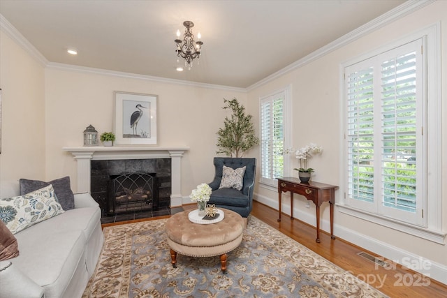 12048 Royal Portrush Dr, Charlotte, NC 28277 - sitting room with crown molding, a fireplace, a chandelier, baseboards, and wood finished floors