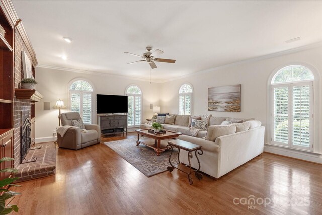 12048 Royal Portrush Dr, Charlotte, NC 28277 - living area with a fireplace, a ceiling fan, wood finished floors, and a wealth of natural light