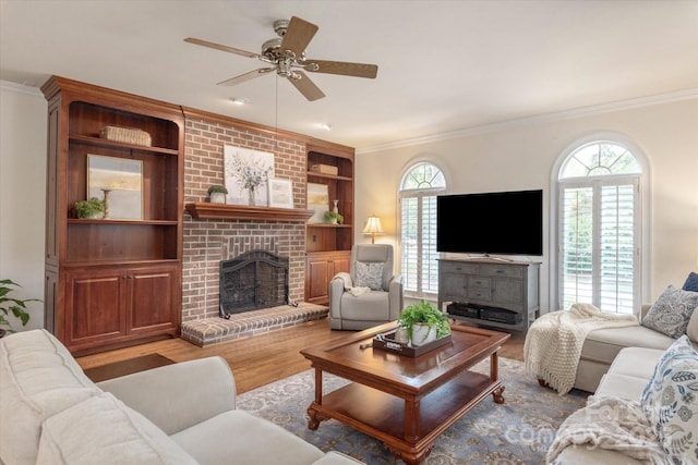 12048 Royal Portrush Dr, Charlotte, NC 28277 - living room featuring a brick fireplace, ceiling fan, ornamental molding, and wood finished floors