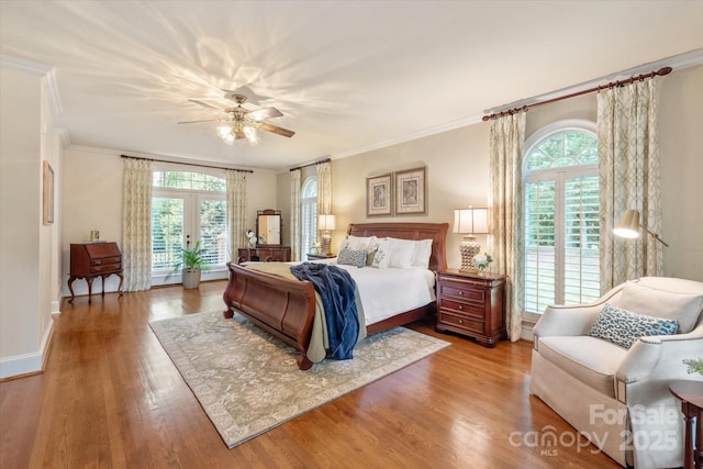 12048 Royal Portrush Dr, Charlotte, NC 28277 - bedroom featuring ornamental molding, wood finished floors, baseboards, ceiling fan, and french doors