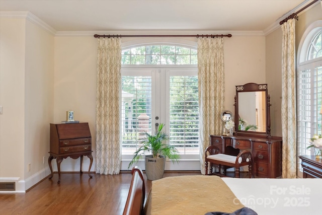 12048 Royal Portrush Dr, Charlotte, NC 28277 - dining space featuring a healthy amount of sunlight, ornamental molding, wood finished floors, and visible vents