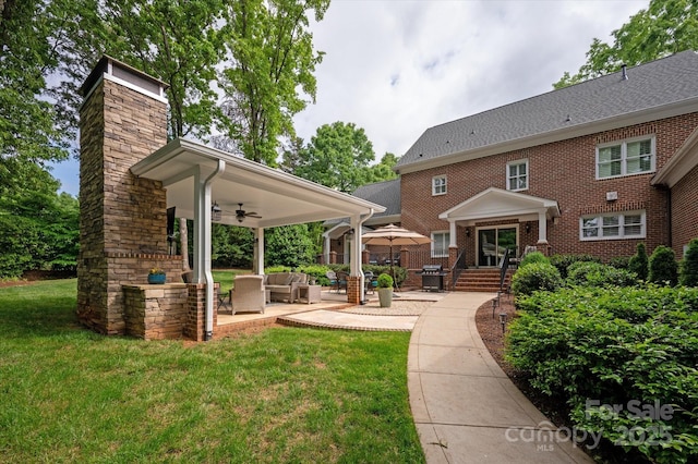 12048 Royal Portrush Dr, Charlotte, NC 28277 - back of property with ceiling fan, outdoor lounge area, a patio, a chimney, and a lawn