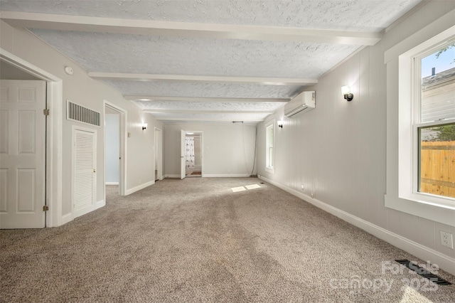 empty room featuring visible vents, beamed ceiling, baseboards, a textured ceiling, and carpet