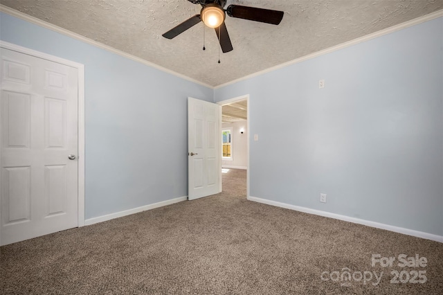 unfurnished bedroom featuring crown molding, baseboards, ceiling fan, a textured ceiling, and carpet