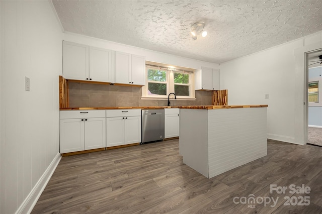 kitchen with wooden counters, dark wood-style floors, a textured ceiling, tasteful backsplash, and dishwasher