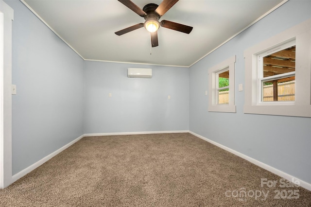unfurnished room featuring a wall unit AC, a ceiling fan, baseboards, ornamental molding, and carpet flooring
