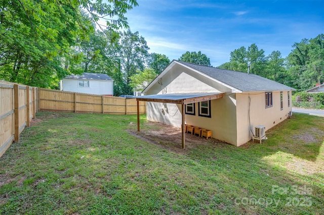 back of property featuring a lawn, ac unit, a fenced backyard, and stucco siding