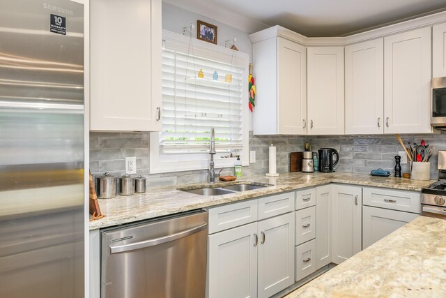 4838 Holbrook Dr, Charlotte, NC 28212 - kitchen featuring stainless steel appliances, a sink, tasteful backsplash, and white cabinets