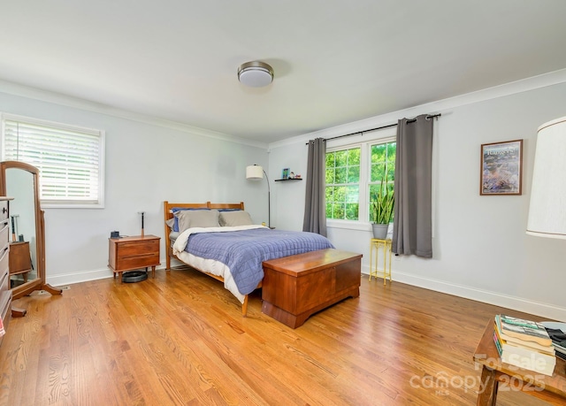 4838 Holbrook Dr, Charlotte, NC 28212 - bedroom with crown molding, multiple windows, light wood finished floors, and baseboards