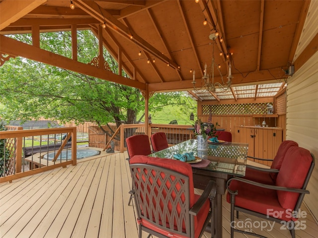 wooden terrace with fence and outdoor dining space