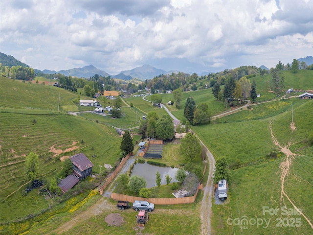drone / aerial view featuring a rural view and a mountain view
