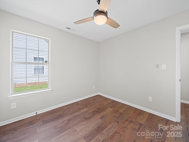 4101 New Castle Ln, Monroe, NC 28110 - empty room featuring a ceiling fan, dark wood-style flooring, and baseboards